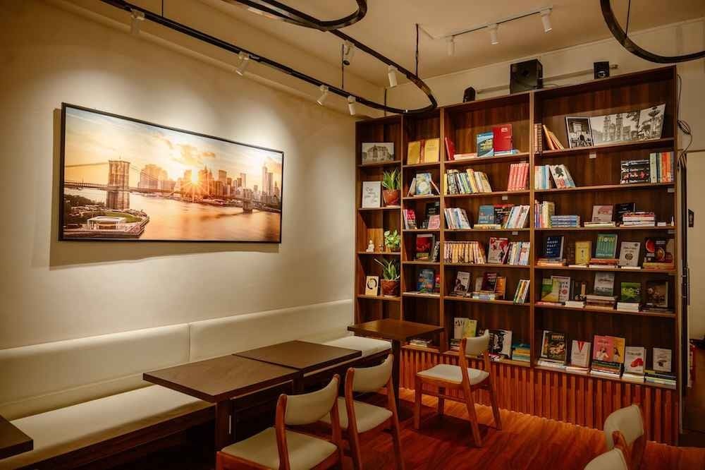 Không gian quán cafe sách với nhạc nền nhẹ và mùi hương cà phê, mang lại trải nghiệm thư giãn